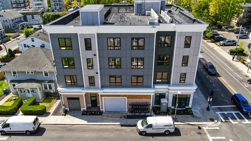 3992 Washington Street, Unit 302 Boston, MA 02131 - Photo 29 of 29 a front view of a building with parking