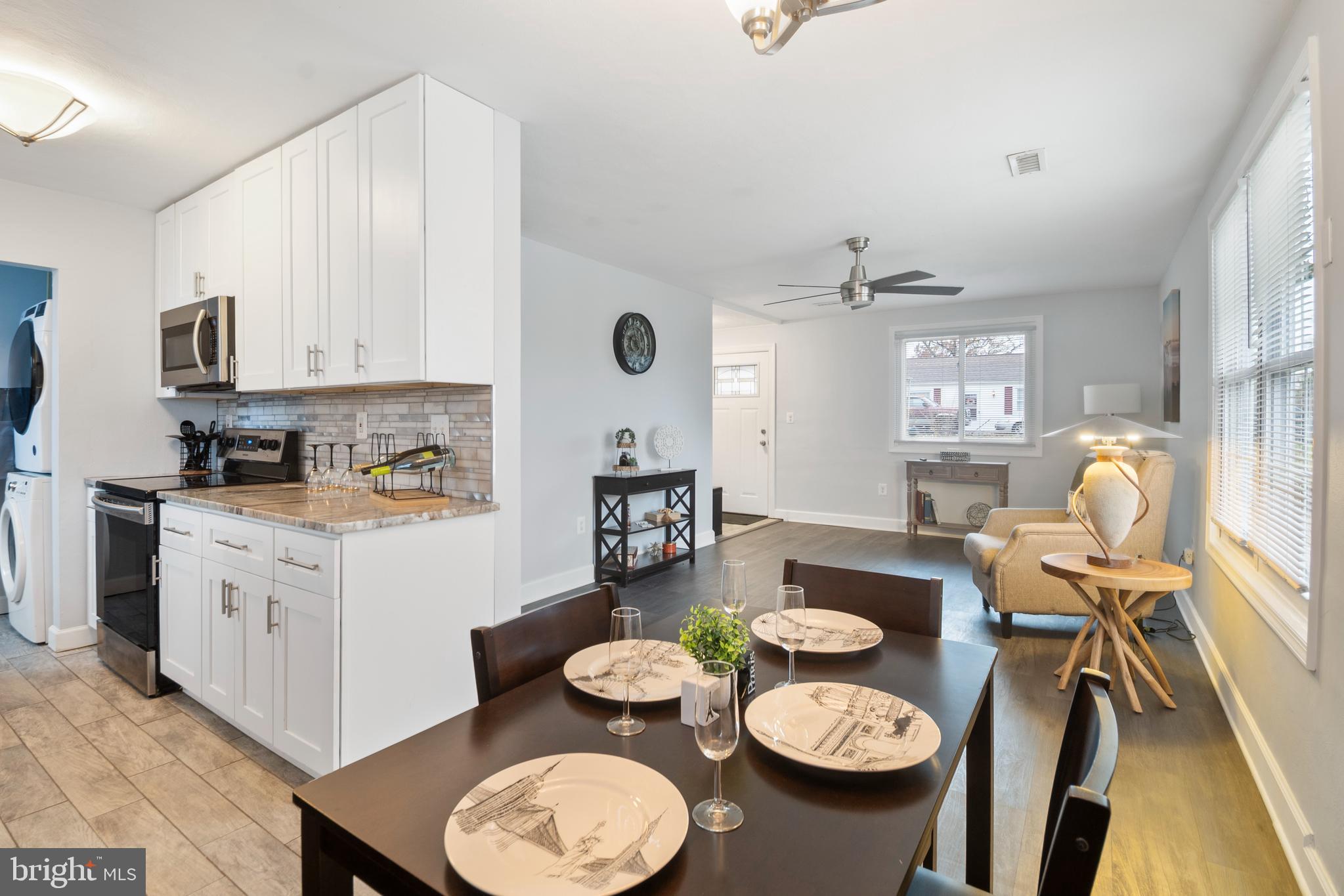 1613 Kimber Road Glen Burnie, MD 21060 - Photo 13 of 39 a kitchen with stainless steel appliances granite countertop a dining table and chairs in it