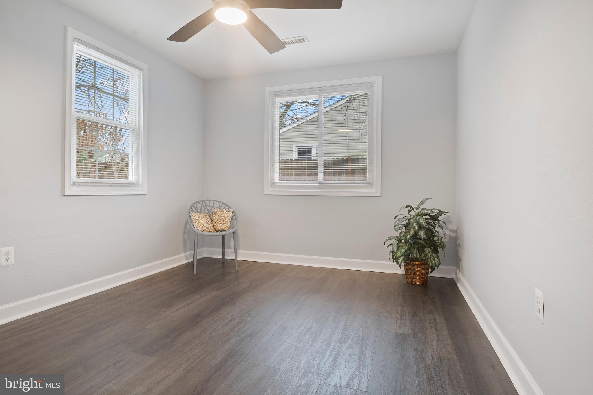 1613 Kimber Road Glen Burnie, MD 21060 - Photo 23 of 39 an empty room with wooden floor and windows