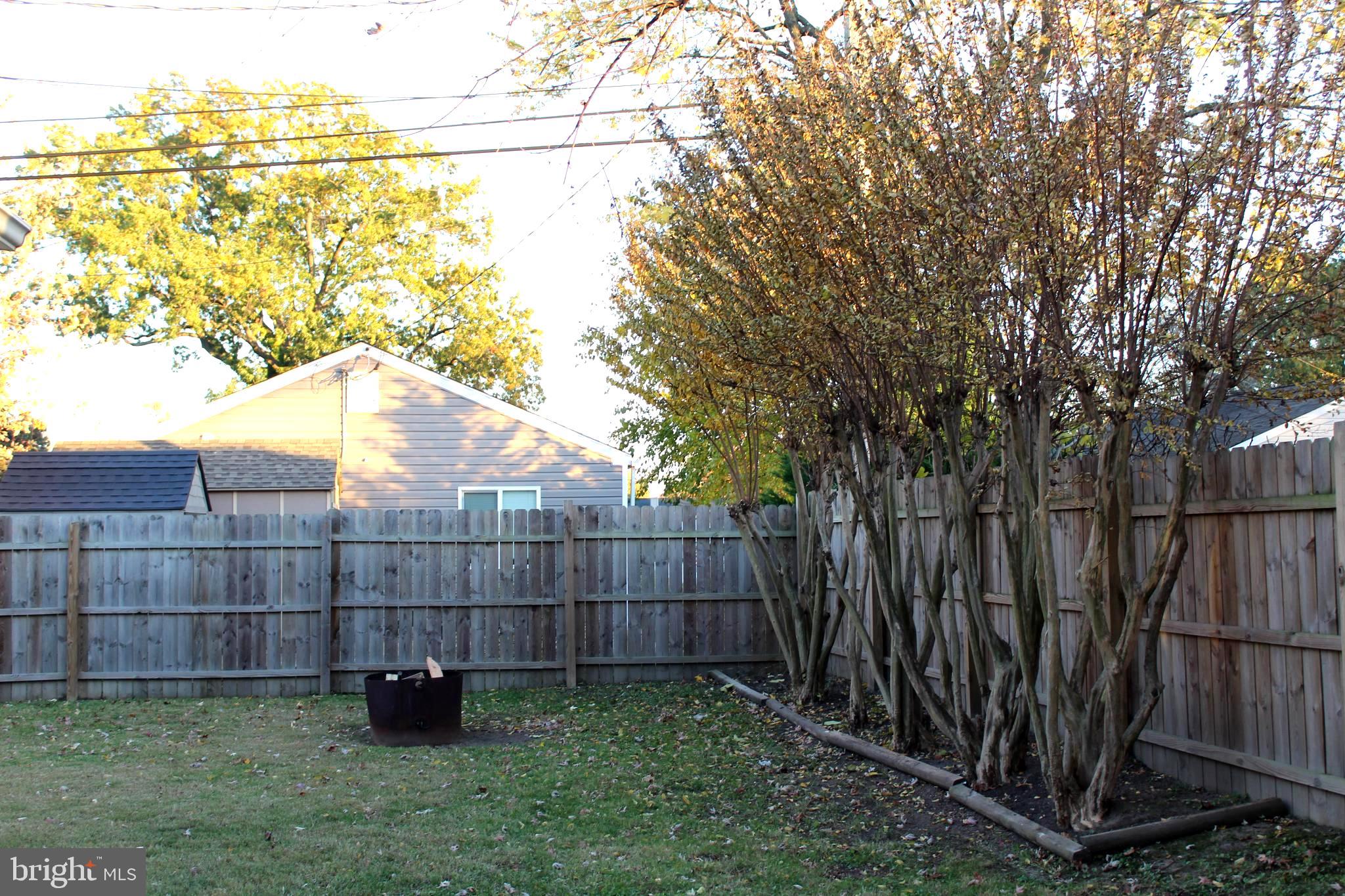 1613 Kimber Road Glen Burnie, MD 21060 - Photo 32 of 39 a view of a backyard with wooden fence and plants