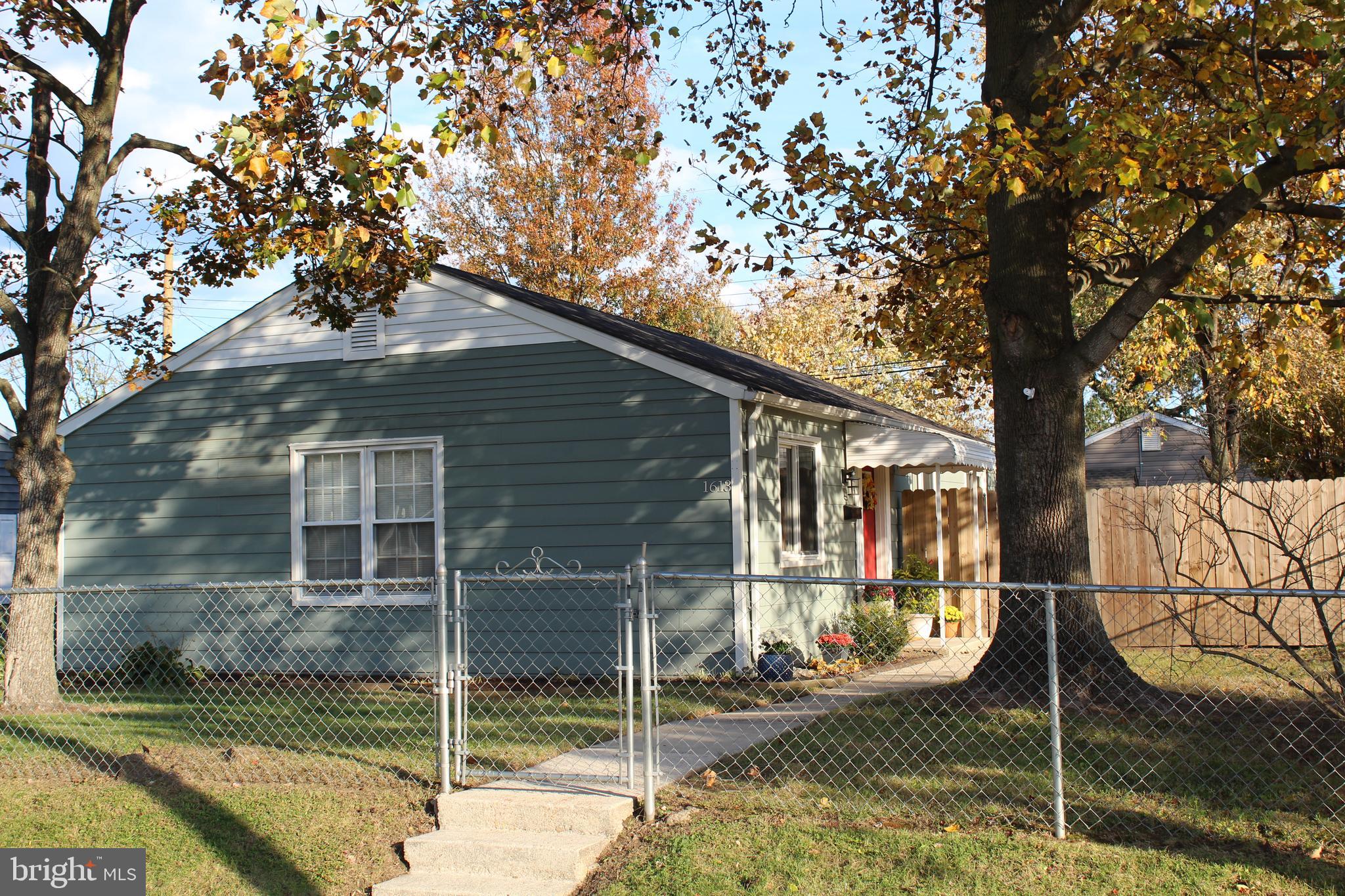 1613 Kimber Road Glen Burnie, MD 21060 - Photo 38 of 39 a house with trees in front of it