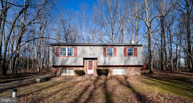 a view of a house with a yard covered in snow