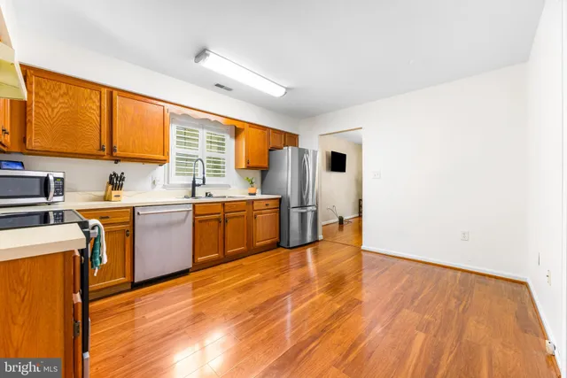 a view of a kitchen with wooden floor