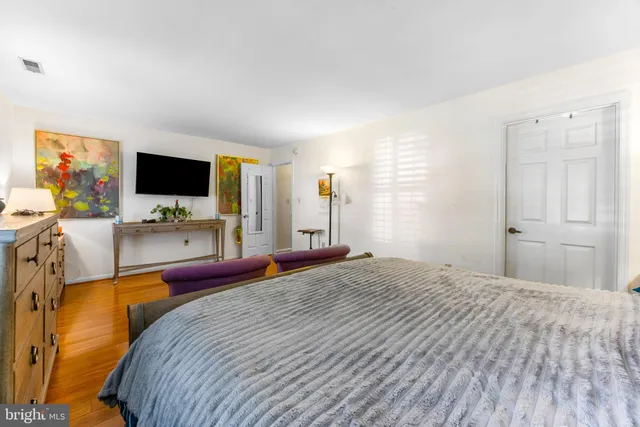 a bedroom with a bed and flat screen tv