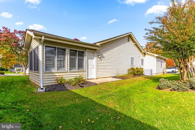 a front view of house with yard and outdoor seating