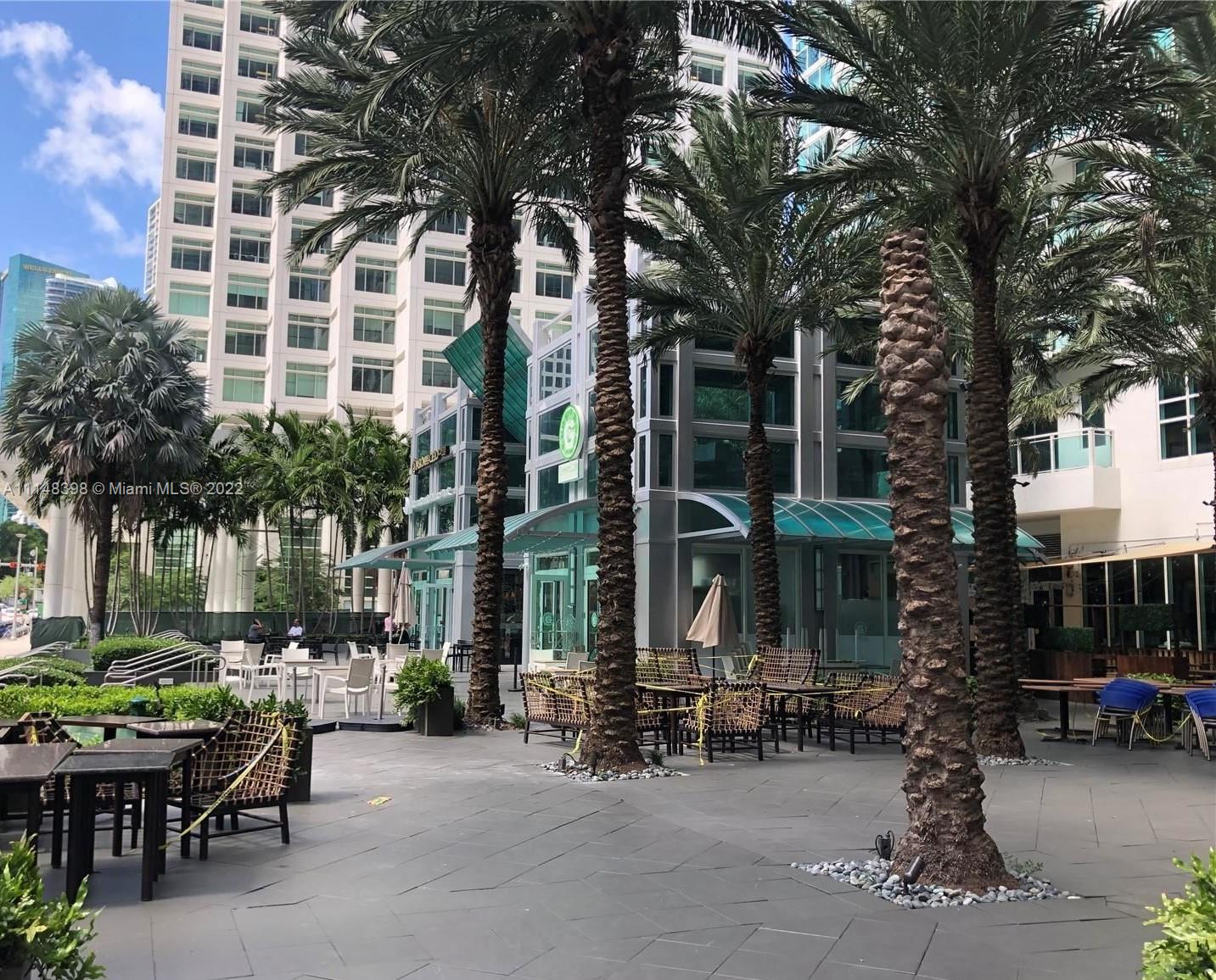 a row of table and chairs in front of building