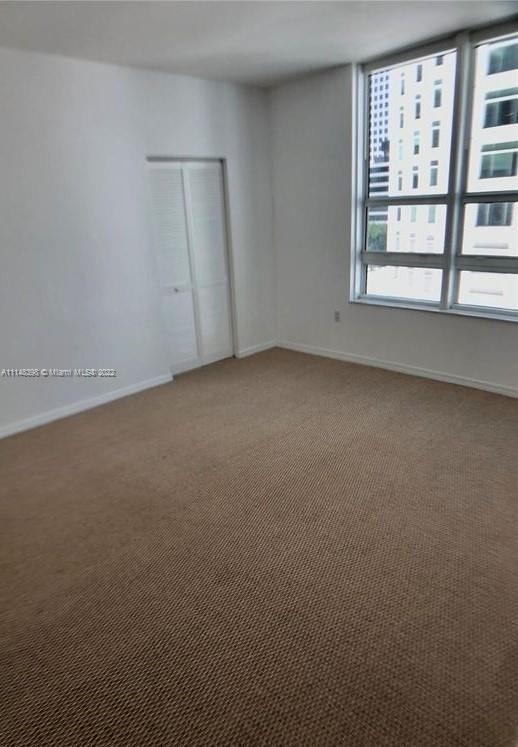 950 Brickell Bay Drive, Unit 602 Miami, FL 33131 - Photo 11 of 20 an empty room with windows