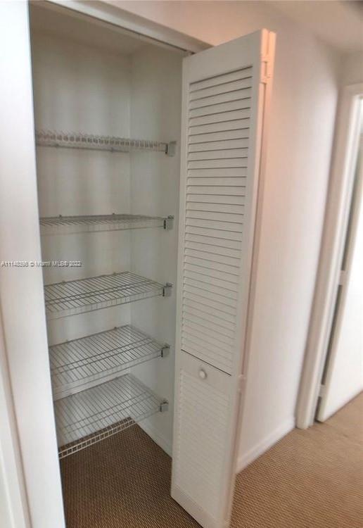 950 Brickell Bay Drive, Unit 602 Miami, FL 33131 - Photo 15 of 20 a view of walk in closet with empty racks