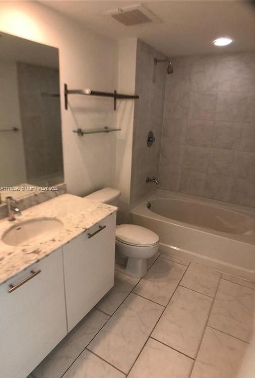 950 Brickell Bay Drive, Unit 602 Miami, FL 33131 - Photo 16 of 20 a bathroom with a granite countertop sink a toilet and shower