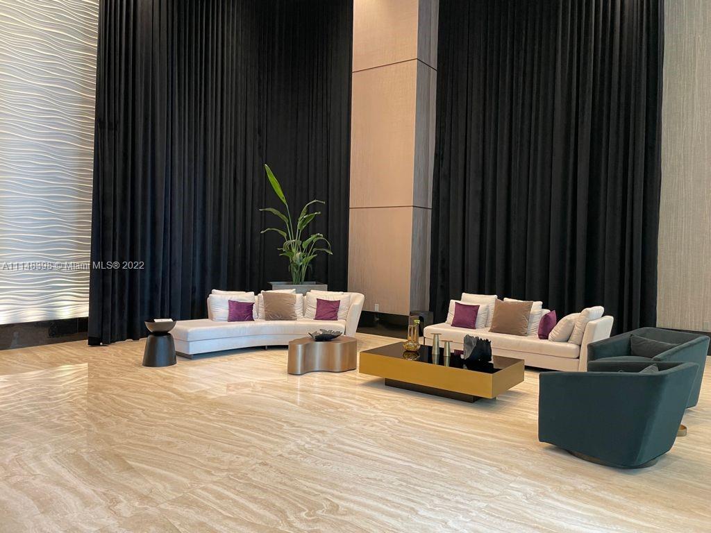 950 Brickell Bay Drive, Unit 602 Miami, FL 33131 - Photo 4 of 20 a living room with furniture and wooden floor