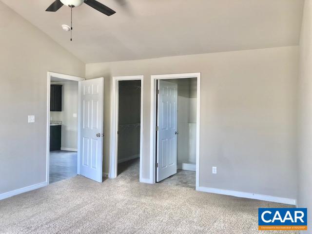 197 Riva Way Palmyra, VA 22963 - Photo 19 of 33 an empty room with chandelier fan and kitchen view