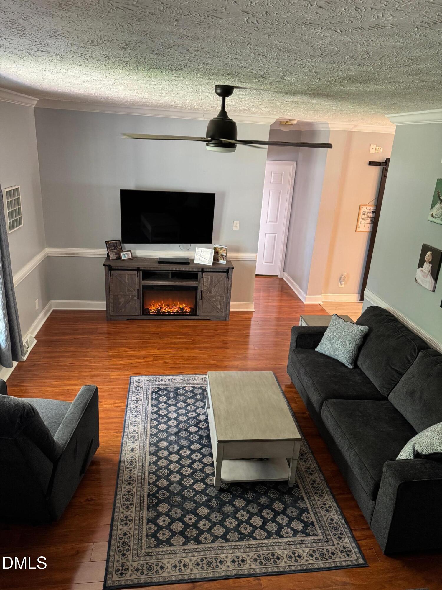 129 Family Drive Rougemont, NC 27572 - Photo 11 of 37 a living room with furniture and a flat screen tv