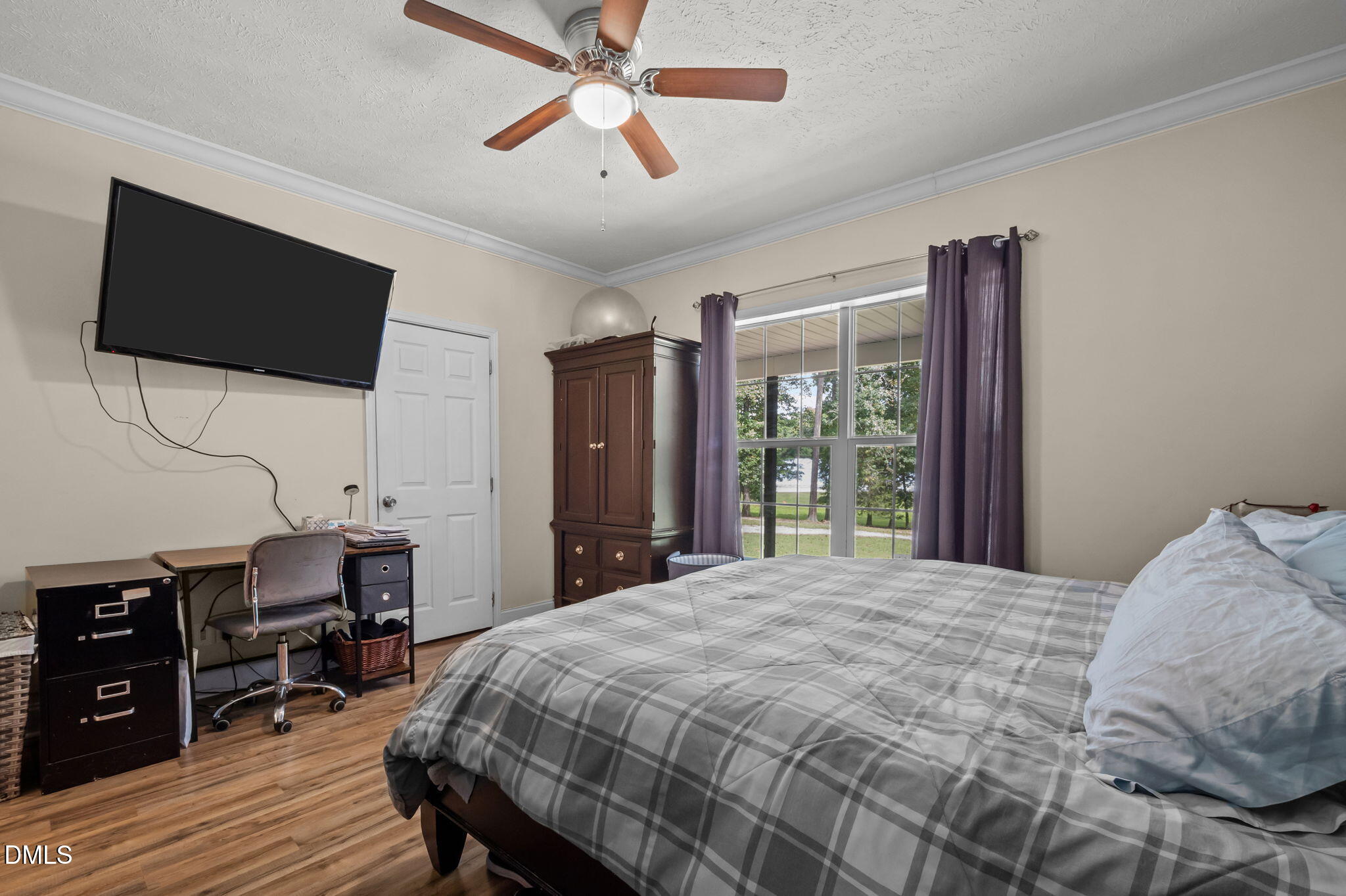 129 Family Drive Rougemont, NC 27572 - Photo 13 of 37 a bedroom with a bed a flat screen tv and a chandelier