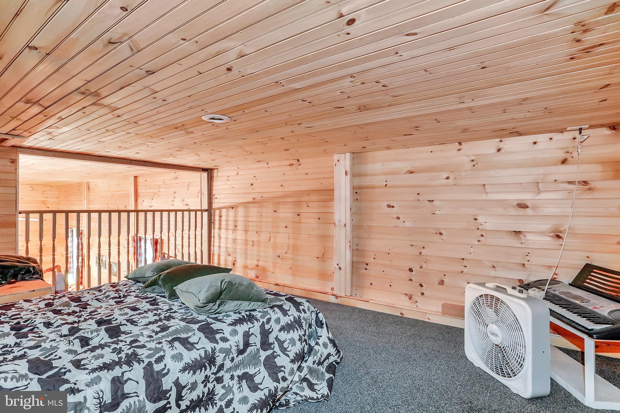 25-20 Rocky Road Falling Waters, WV 25419 - Photo 15 of 25 a bedroom with a bed and wooden floor