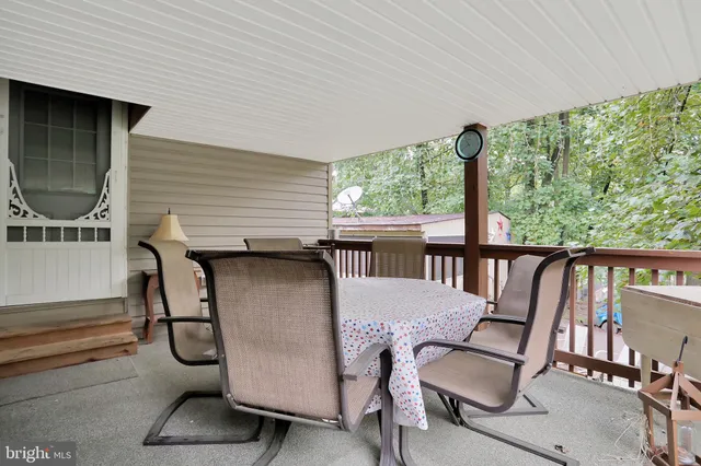 a view of balcony with wooden floor and outdoor seating