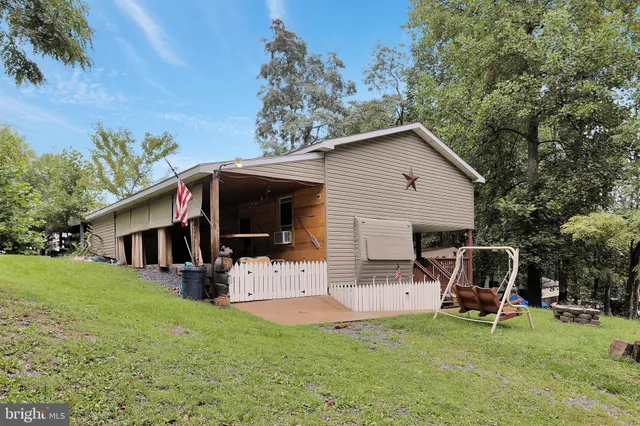 a view of house with backyard space and sitting area