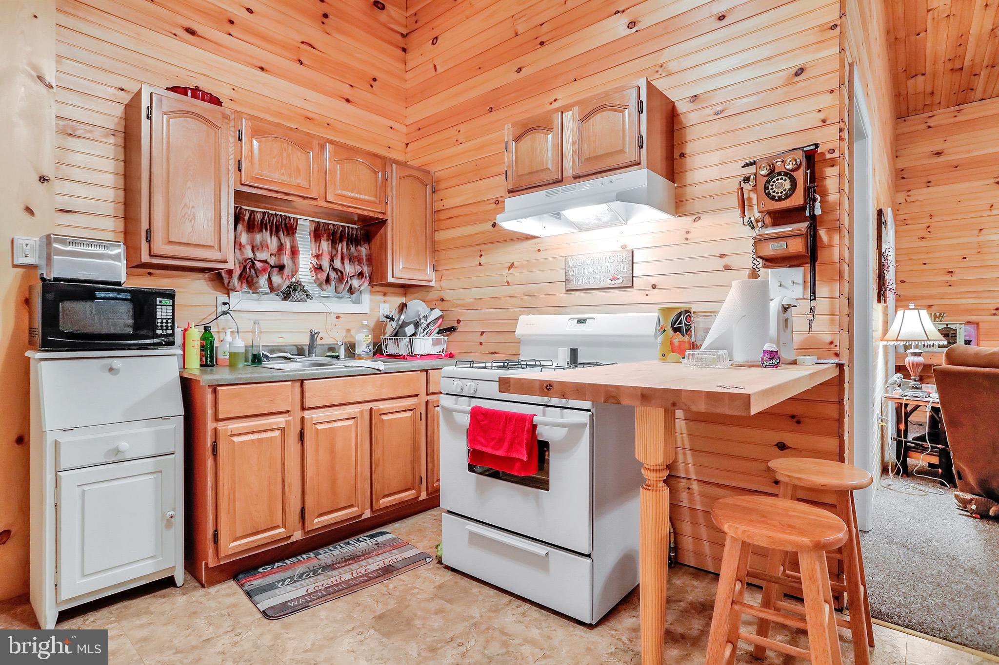 25-20 Rocky Road Falling Waters, WV 25419 - Photo 6 of 25 a kitchen with stainless steel appliances granite countertop a sink and cabinets