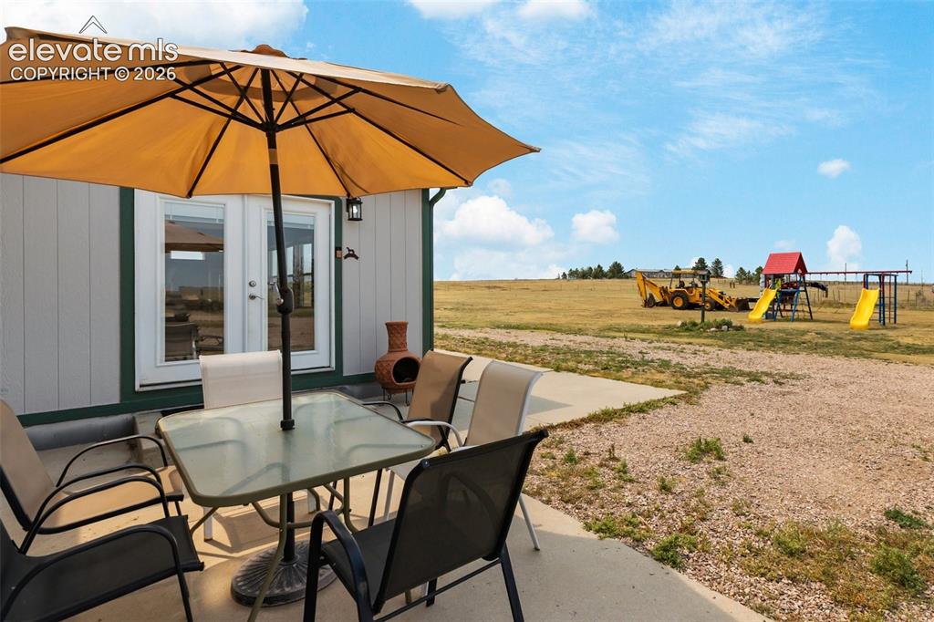 1350 South Calhan Highway Yoder, CO 80864 - Photo 9 of 45 Concrete patio area featuring direct outdoor access