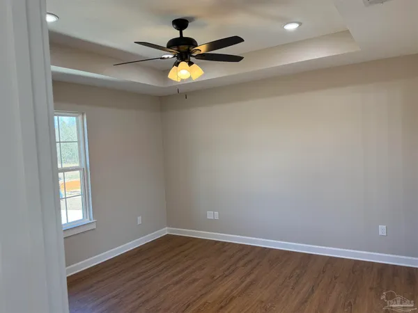 wooden floor in an empty room with a window
