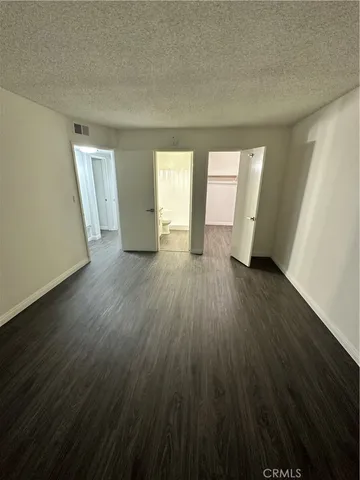 an empty room with wooden floor