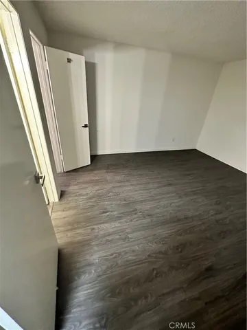 a view of a room with wooden floor and window