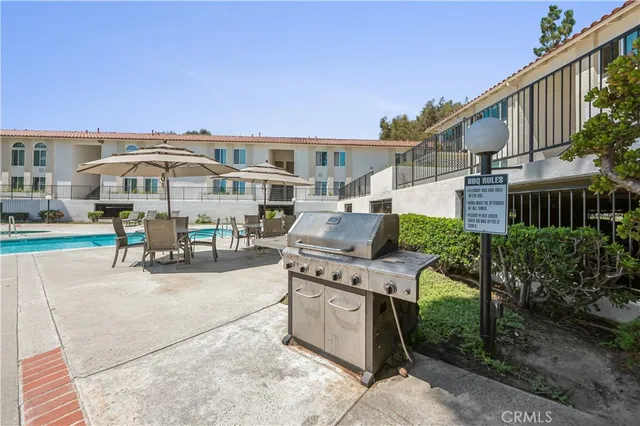 a swimming pool with outdoor seating and yard