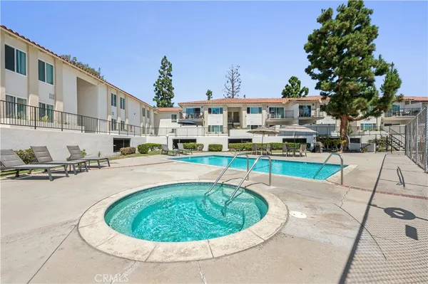 a swimming pool view with a seating space and a garden