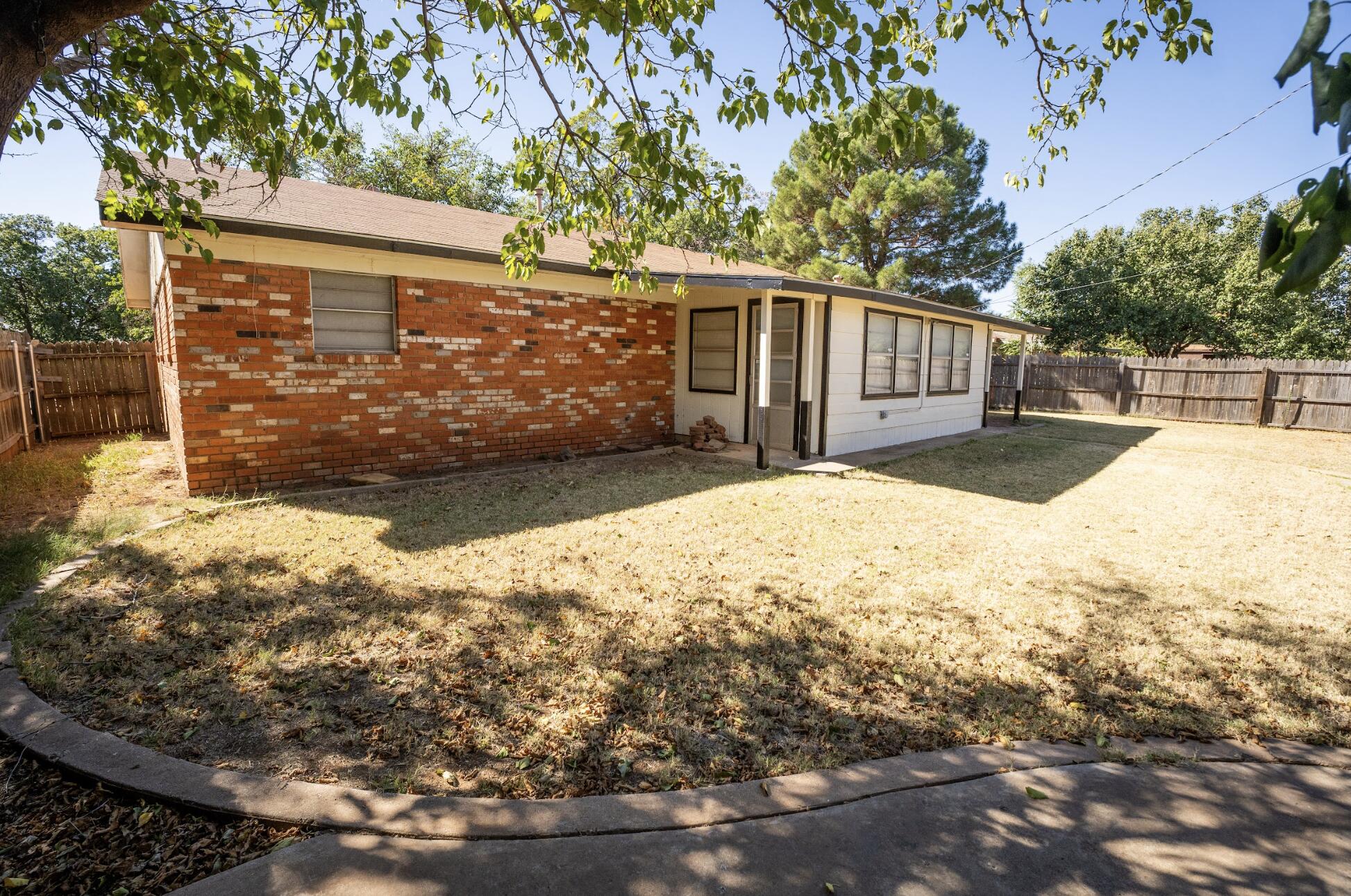5314 46th Street Lubbock, TX 79414 - Photo 14 of 15 a view of a yard with wooden fence