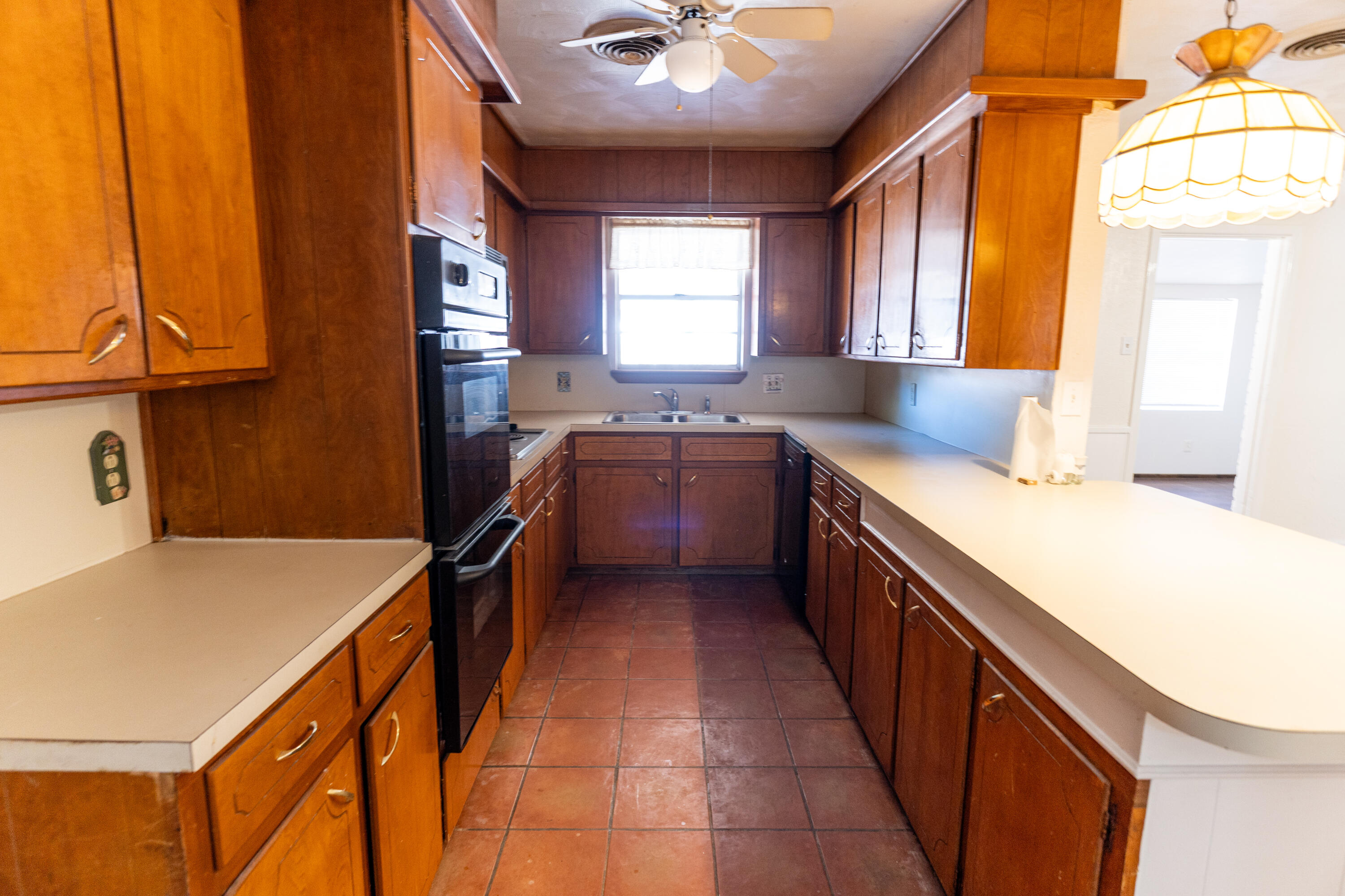 5314 46th Street Lubbock, TX 79414 - Photo 4 of 15 a kitchen with a sink and wooden cabinets