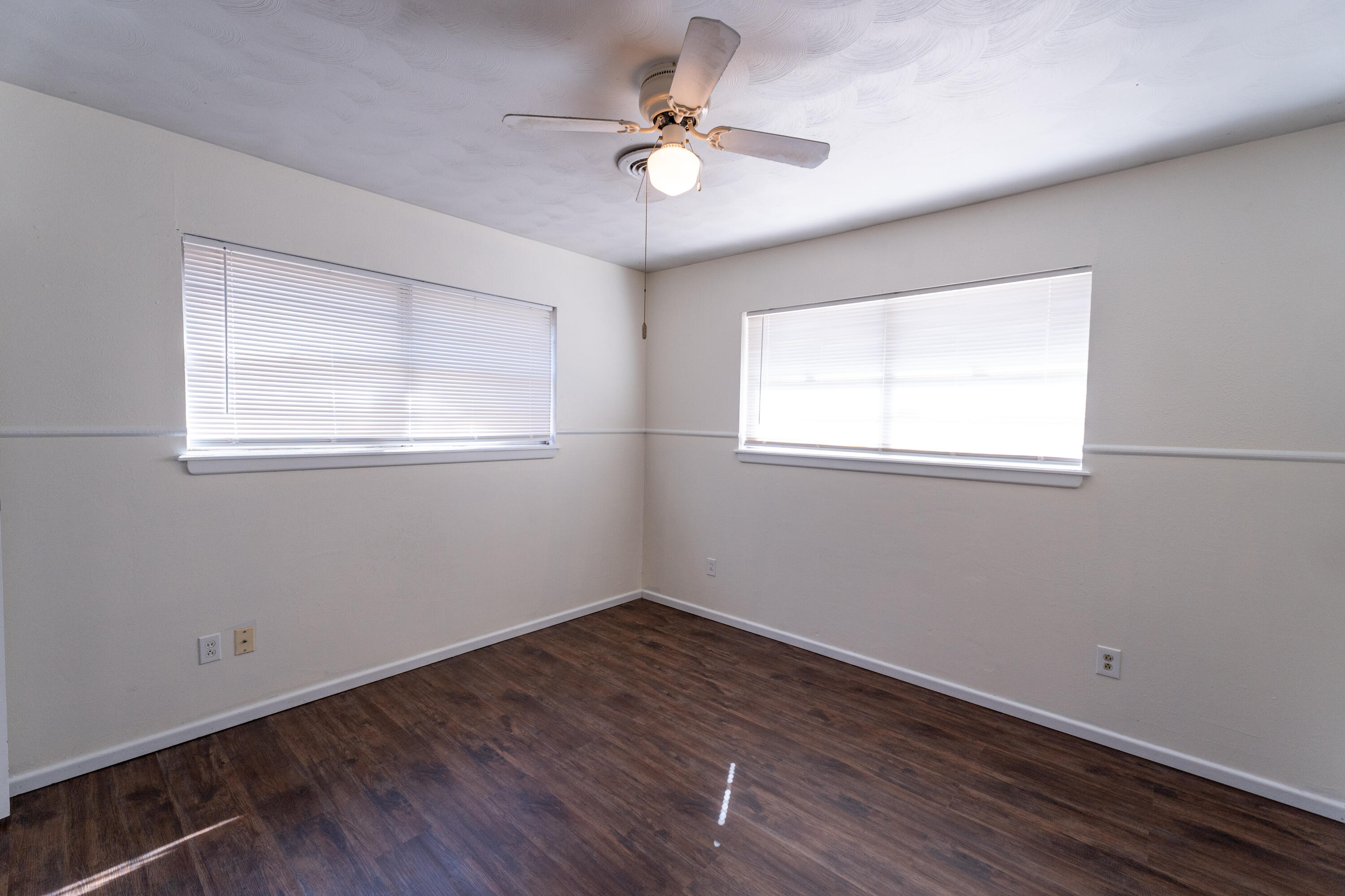 5314 46th Street Lubbock, TX 79414 - Photo 10 of 15 an empty room with wooden floor and windows