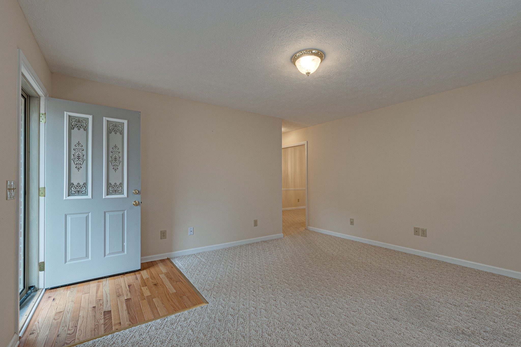 188 Zachary Road Lebanon, TN 37090 - Photo 4 of 29 an empty room with wooden floor and windows