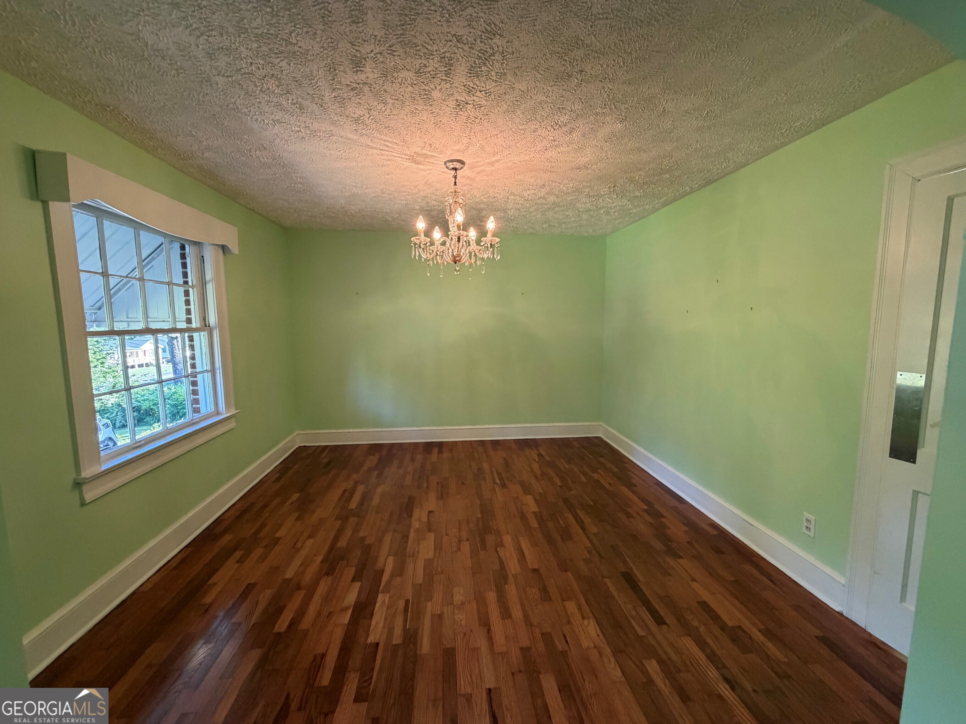 2619 Maple Road Southeast Rome, GA 30161 - Photo 11 of 31 a view of empty room with window and wooden floor