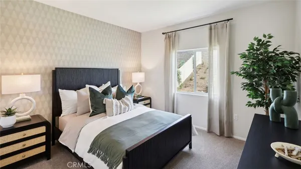 a bedroom with a bed and a potted plant