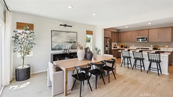 a view of a dining room with furniture and wooden floor