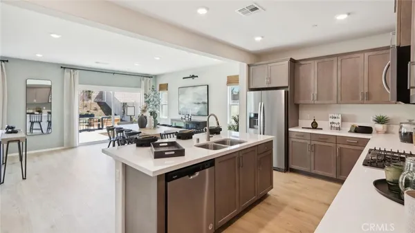 a kitchen with a sink stove and refrigerator
