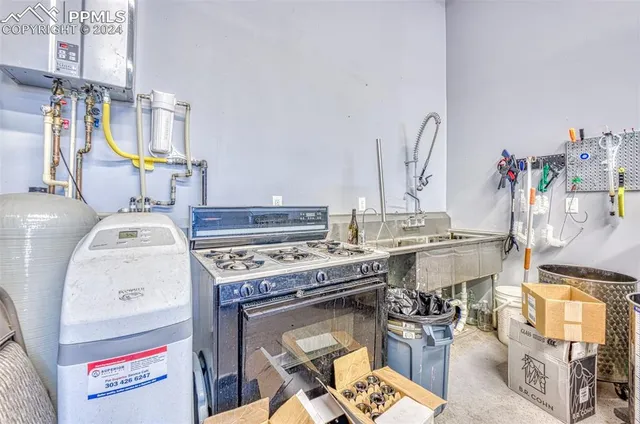 a kitchen with a sink cabinets and appliances