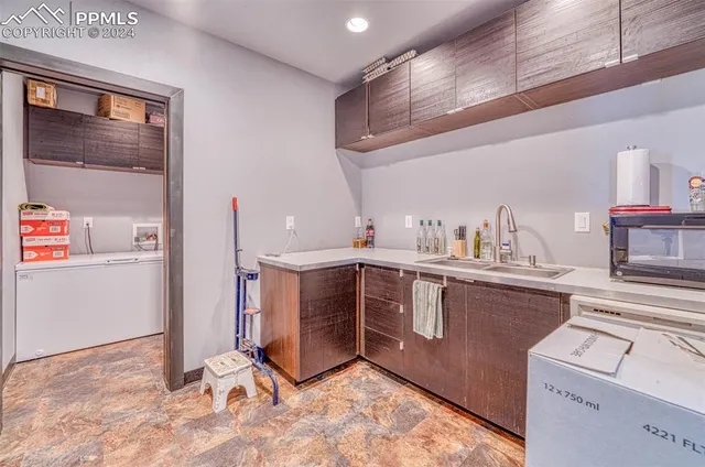 a kitchen with a sink cabinets and window