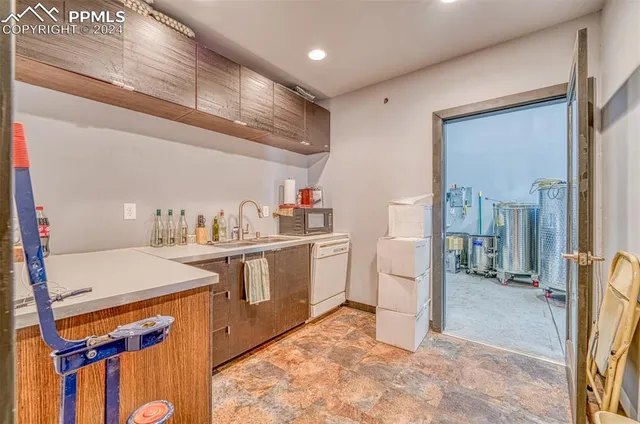 a view of a kitchen with a sink and breakfast area
