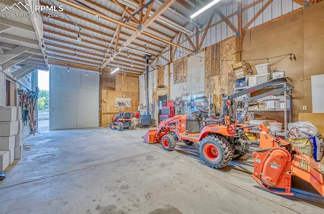 a view of a patio with a table and chairs under an umbrella