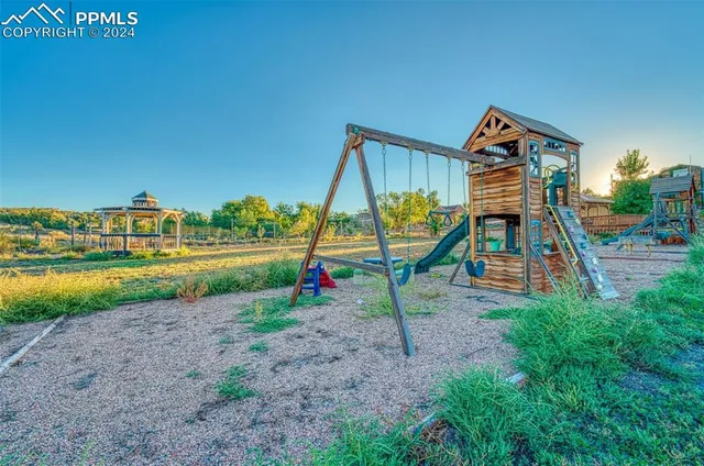 a view of a chairs and table in the balcony