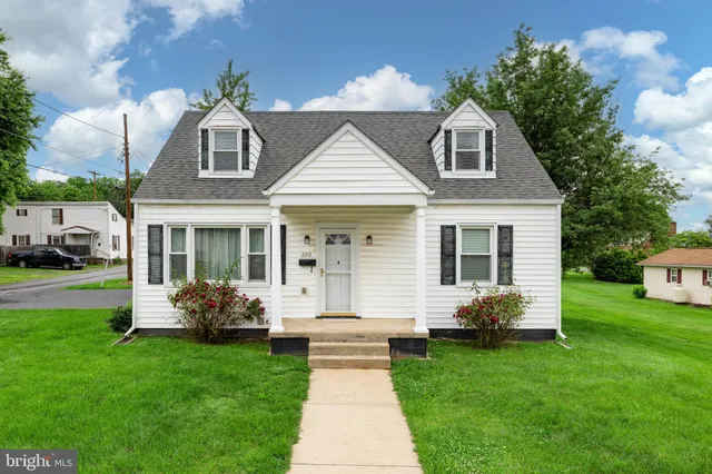 a front view of a house with a garden and plants