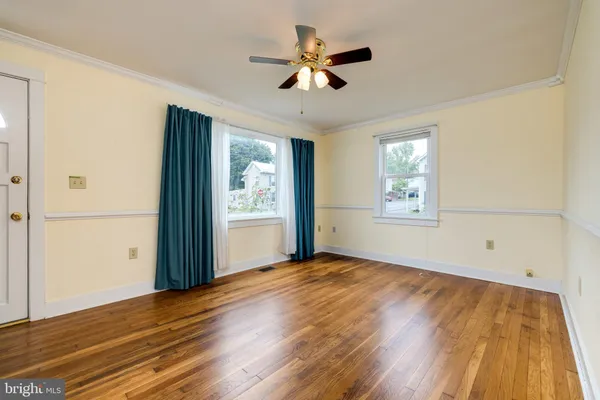 wooden floor in an empty room with a window