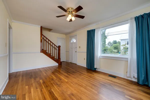 wooden floor in an empty room with a window