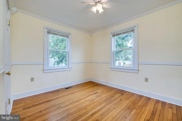 a view of a room with wooden floor and window