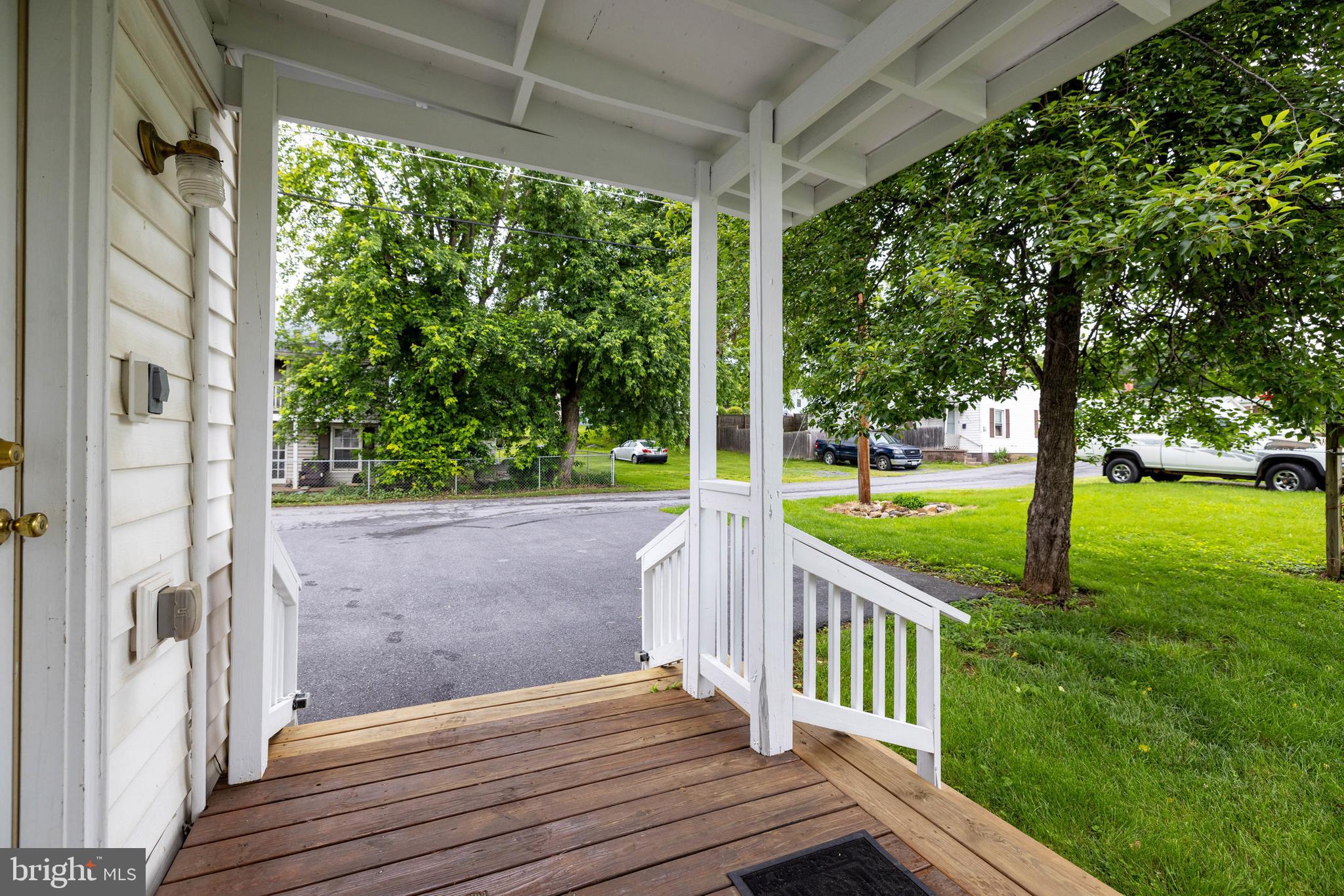 220 Mechanic Street Luray, VA 22835 - Photo 44 of 45 a view of a deck with a big yard potted plants and large tree