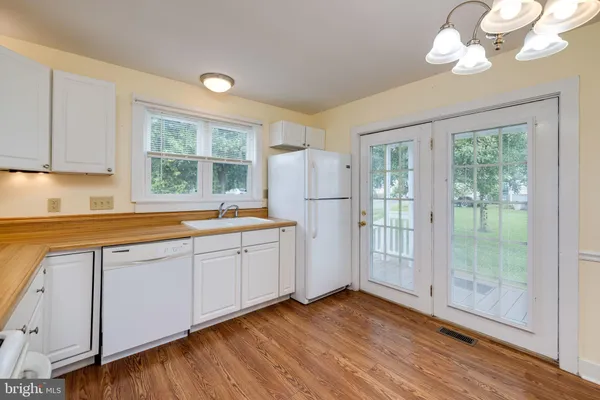 a kitchen with sink cabinets and wooden floor