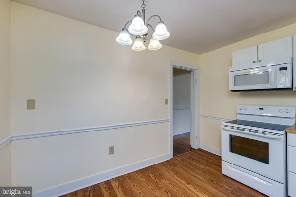 a kitchen with a stove and a white cabinet