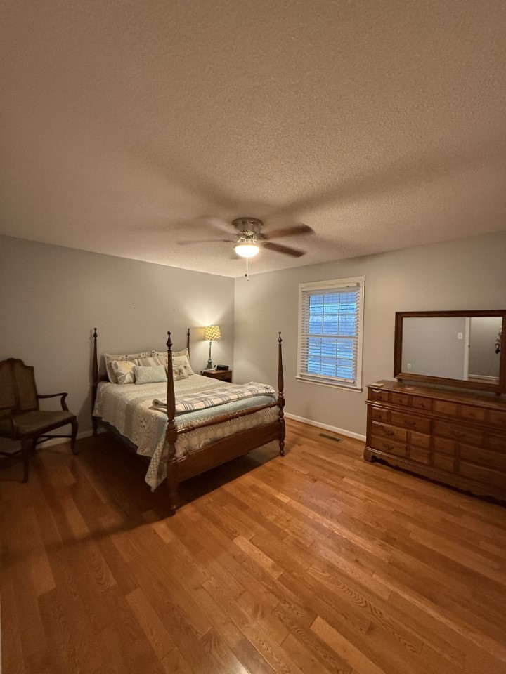 405 Robins Street Lawrenceburg, TN 38464 - Photo 22 of 49 a spacious bedroom with a bed and wooden floor