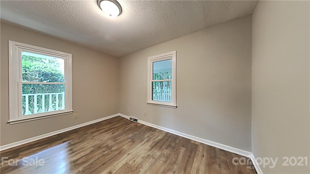 1606 Willowbrook Drive Fort Mill, SC 29708 - Photo 2 of 12 an empty room with wooden floor and windows