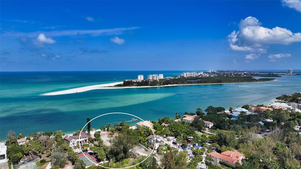 4105 North Shell Road Sarasota, FL 34242 - Photo 2 of 26 a view of a lake with a building in the background
